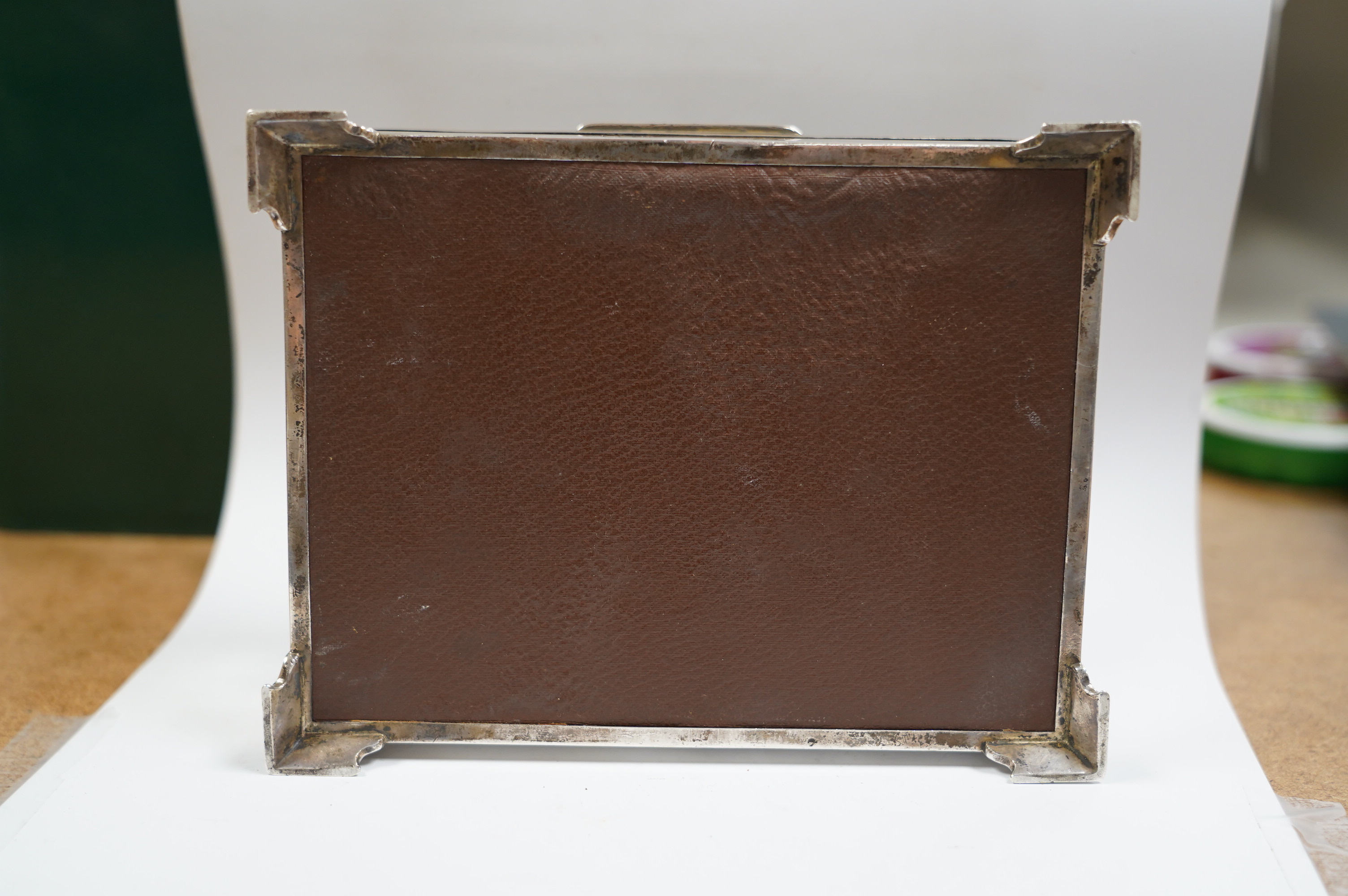 A George VI part engine turned silver cigarette box, Birmingham, 1948, with engraved inscription, on bracket feet, 17.3cm. Condition - poor